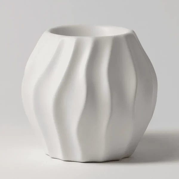 White ceramic Scentsy warmer with a ribbed, wave-like texture curving around its rounded body, the Cascade Scentsy Warmer