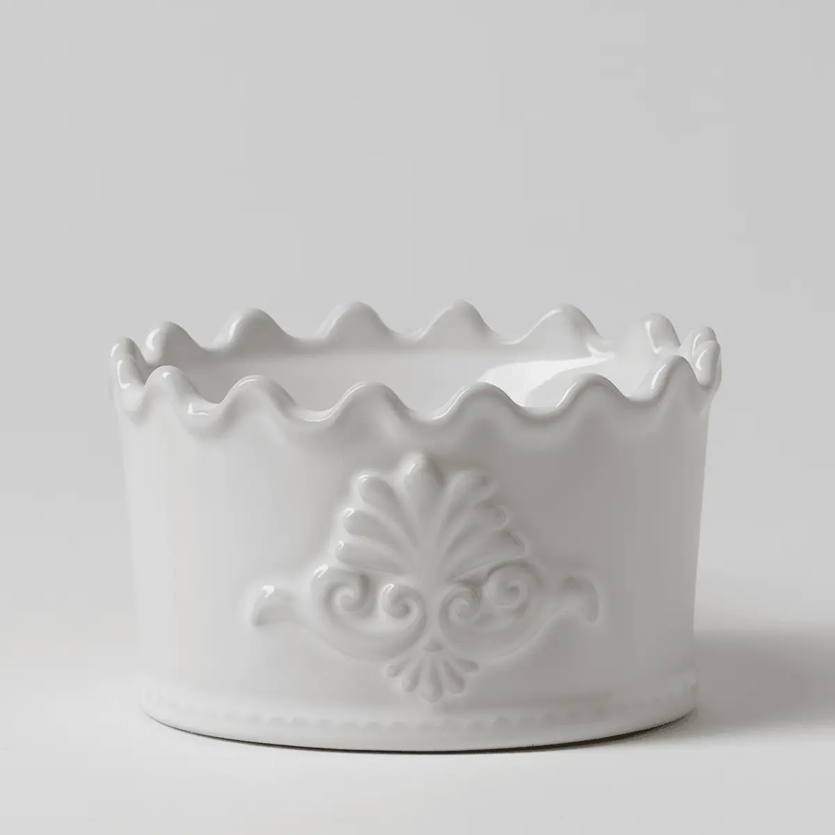 White ceramic Scentsy warmer with a scalloped wavy rim and ornate shell and scroll relief detailing, the Classic Crest Scentsy Warmer