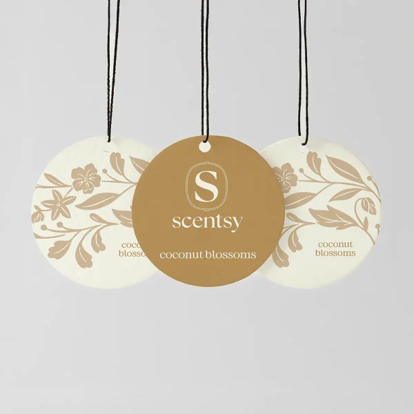 Three hanging Scent Circles with black cords: two cream circles with beige floral and leaf designs, and a centre gold circle featuring the Scentsy logo, for the Coconut Blossoms Scent Circle 3-pack