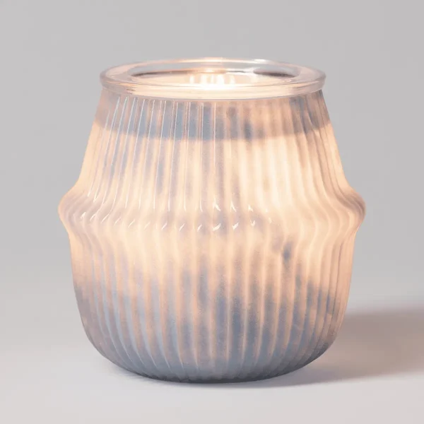 Translucent glass warmer with vertical ribbed texture and softly rounded silhouette, the Gossamer Haze Scentsy Warmer, glowing warmly when lit
