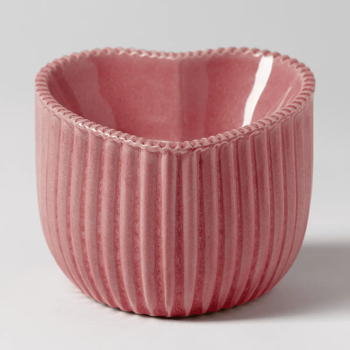 Pink ribbed ceramic warmer with a curved, organic silhouette and decorative rope trim around the rim, the Heart of Hope Scentsy Warmer