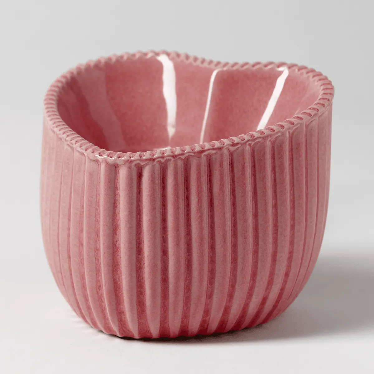 Rose-pink ceramic warmer with vertical ribbed texture and braided rim detail, the Heart of Hope Scentsy Warmer