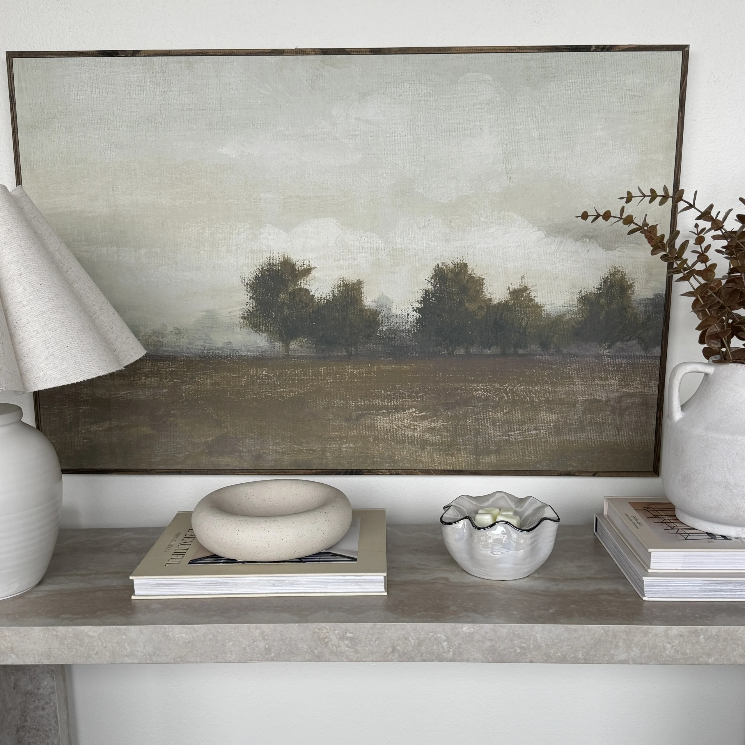 Cream ceramic warmer with a smooth, rounded dome shape, the Lustra Scentsy Warmer, displayed on a shelf with home décor