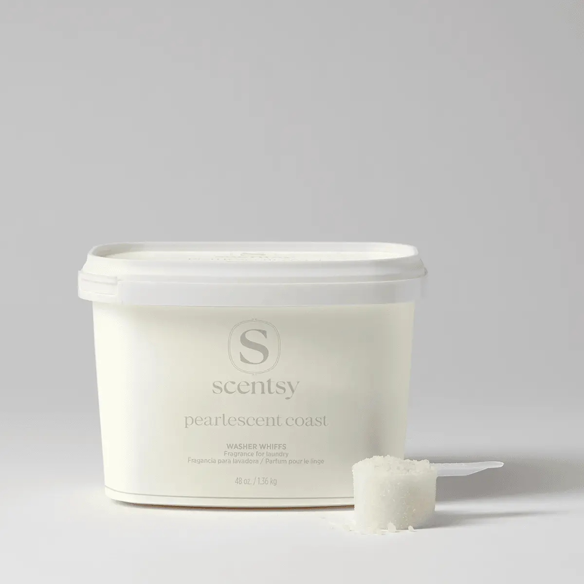 Pearlescent Coast Washer Whiffs Tub - Cream-coloured tub of Pearlescent Coast Washer Whiffs with white lid and measuring scoop, containing laundry fragrance product