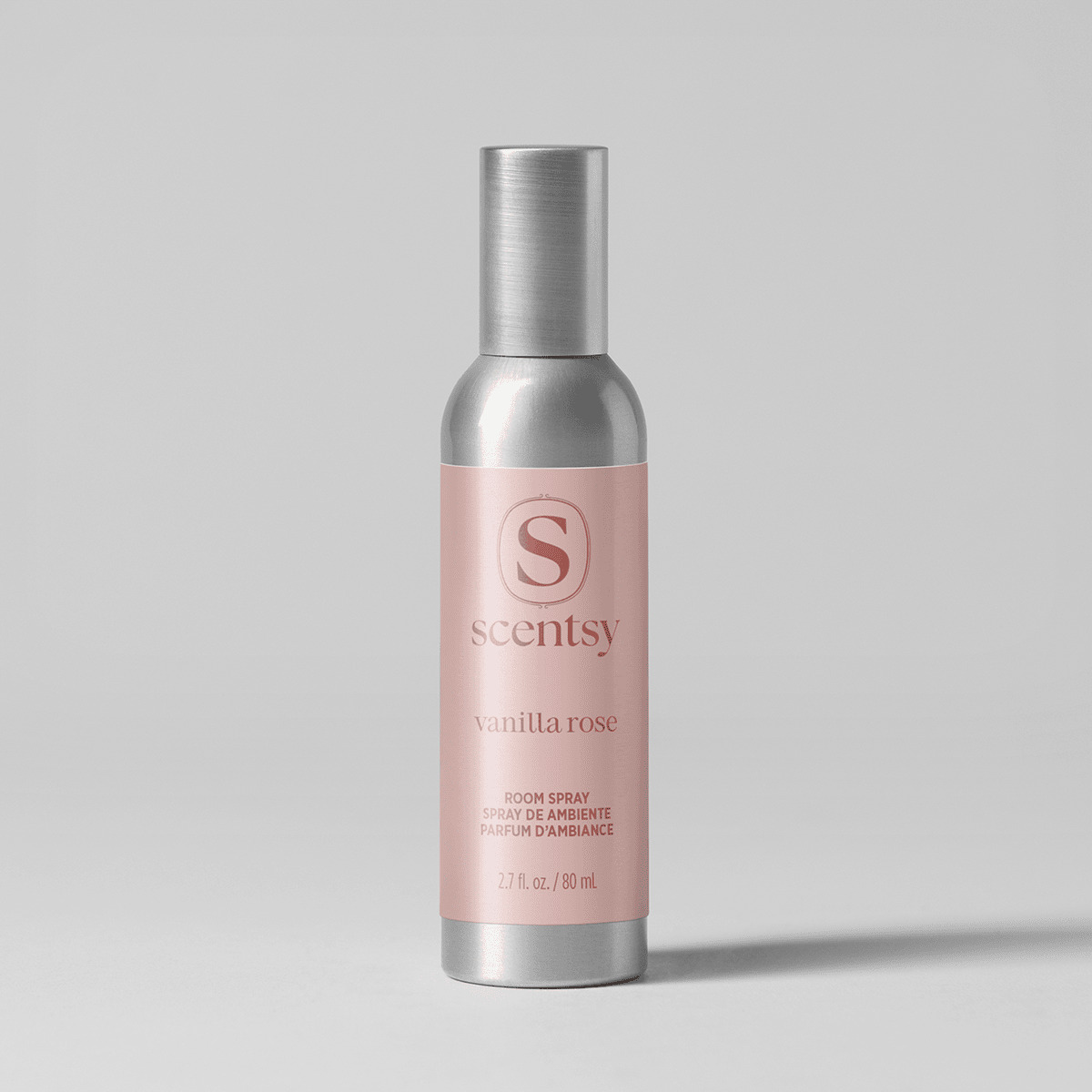 Brushed silver aluminium bottle with a matching cap and soft pink label, the Vanilla Rose Room Spray, shown against a pale grey background