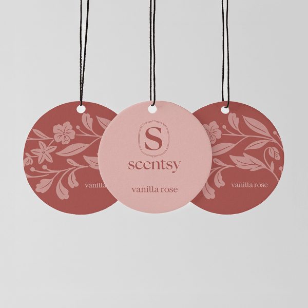 Three circular Scent Circles with black strings, in dusty rose and terracotta tones featuring floral and leaf patterns, the centre circle in pale pink with embossed Scentsy logo, the Vanilla Rose Scent Circle 3-pack