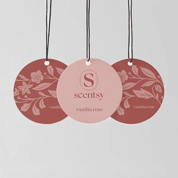 Three circular Scent Circles with black strings, in dusty rose and terracotta tones featuring floral and leaf patterns, the centre circle in pale pink with embossed Scentsy logo, the Vanilla Rose Scent Circle 3-pack