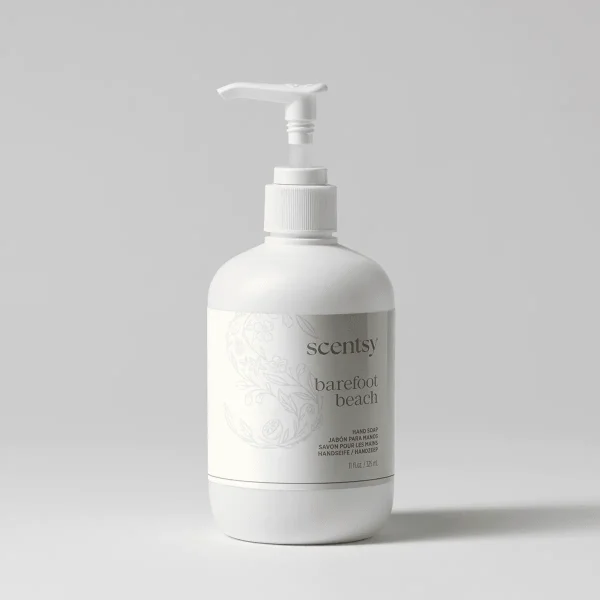White pump bottle of Barefoot Beach Hand Soap with embossed floral design and grey label on neutral background