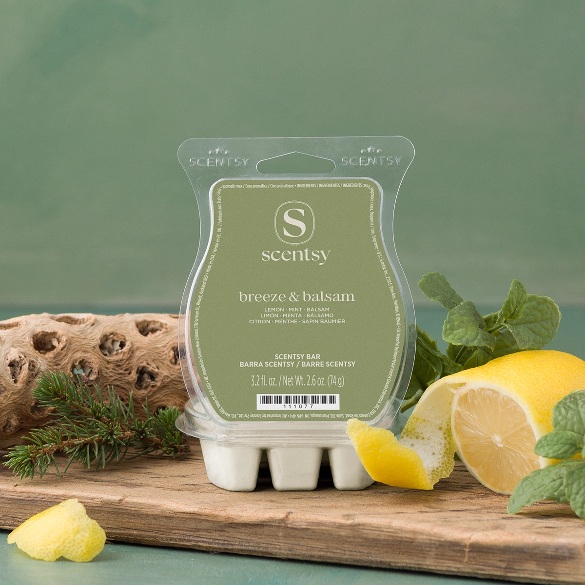 Pale green Scentsy Bar wax melt in Breeze & Balsam scent, displayed in clear plastic clamshell packaging on rustic wood with lemon slices and fresh mint leaves against a soft green background