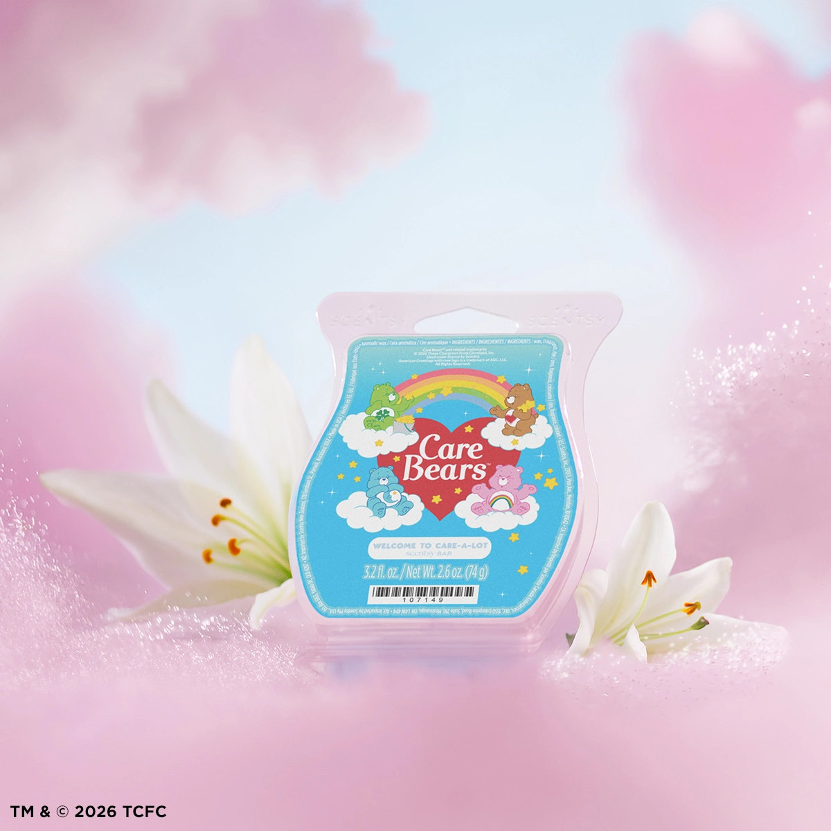 Care Bears-themed wax bar in a clamshell package with a blue label featuring colourful characters, clouds, rainbow and stars, surrounded by white lilies and pink bokeh