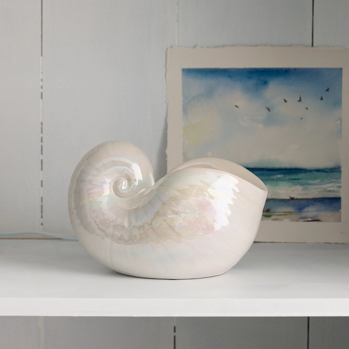 Glossy white ceramic warmer shaped like a nautilus shell with a dimensional spiral detail, the Nautilus Scentsy Warmer