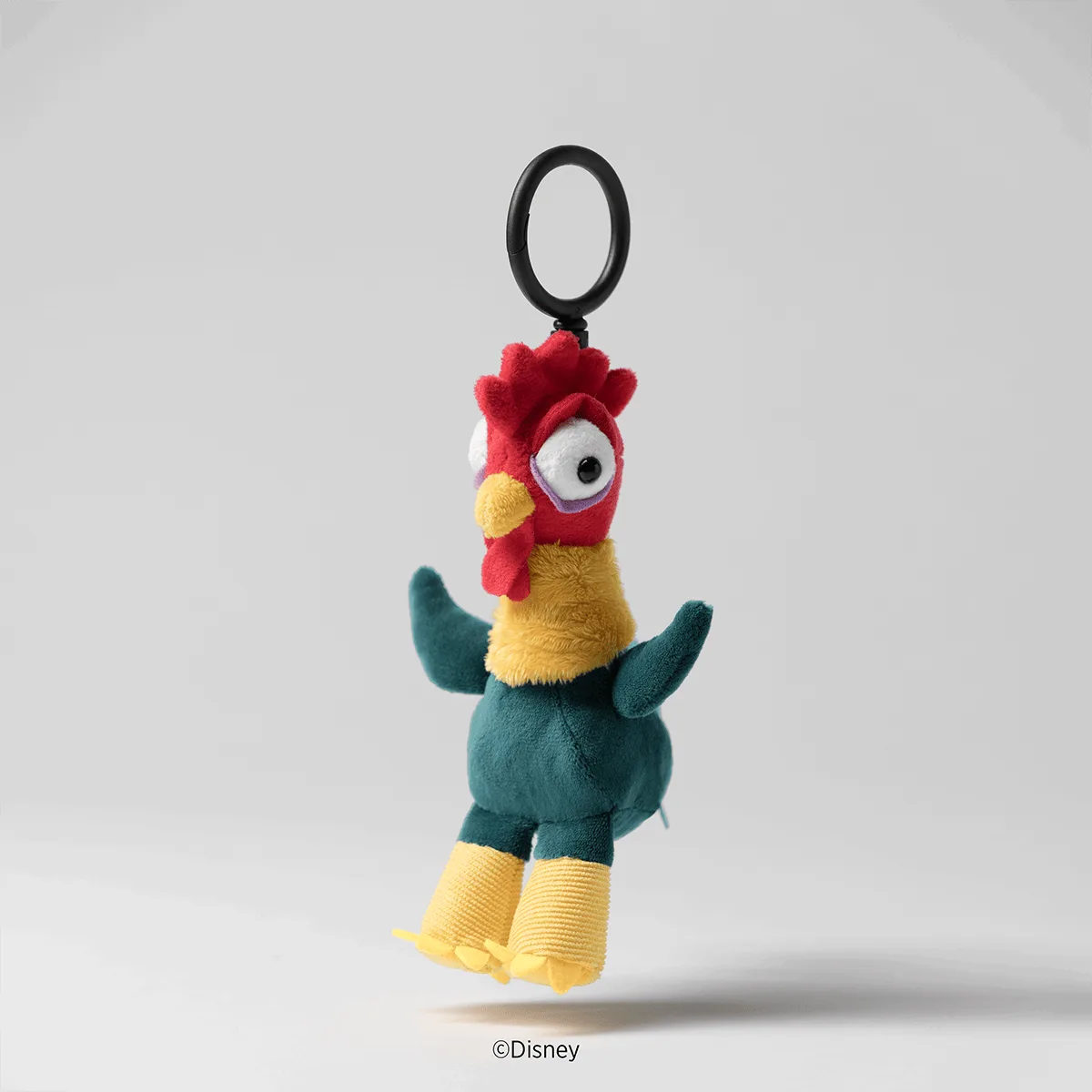 Colorful plush rooster keychain with red head and comb, yellow chest and feet, teal body and wings, wide eye, and black oval clip, the Disney Hei Hei Scentsy Buddy Clip