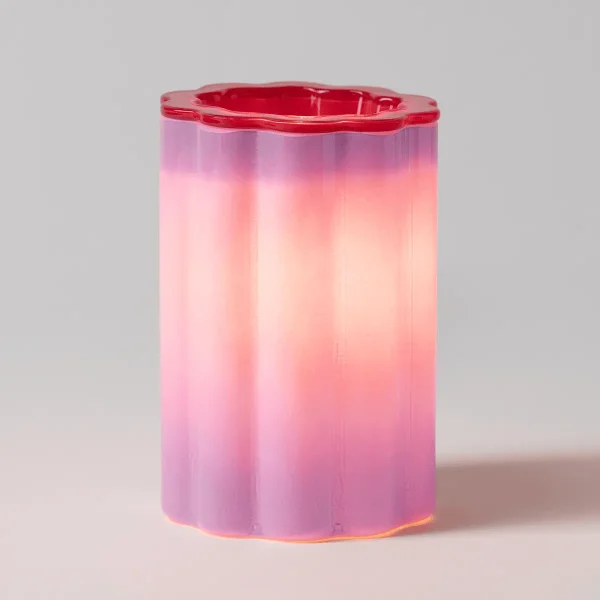 Cylindrical Scentsy Warmer with a wavy rim, featuring a gradient from deep pink at the top through lighter pink and peach to pale cream at the base, the Petal Purple Scentsy Warmer