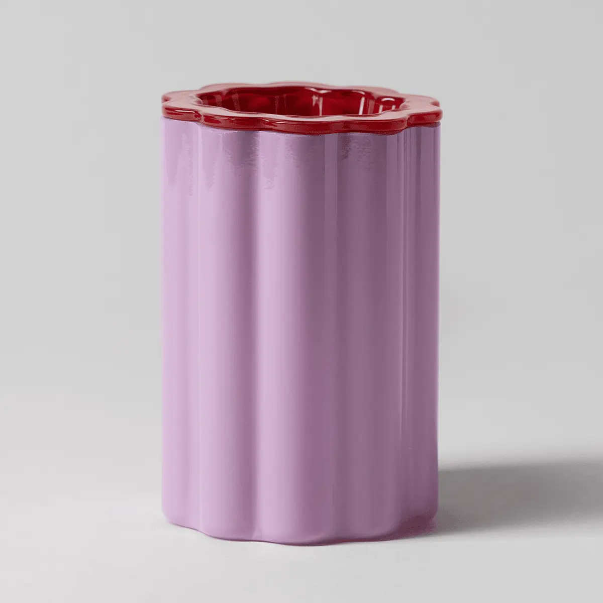 Cylindrical ceramic warmer in soft lavender purple with a scalloped red rim at the top opening, the Petal Purple Scentsy Warmer