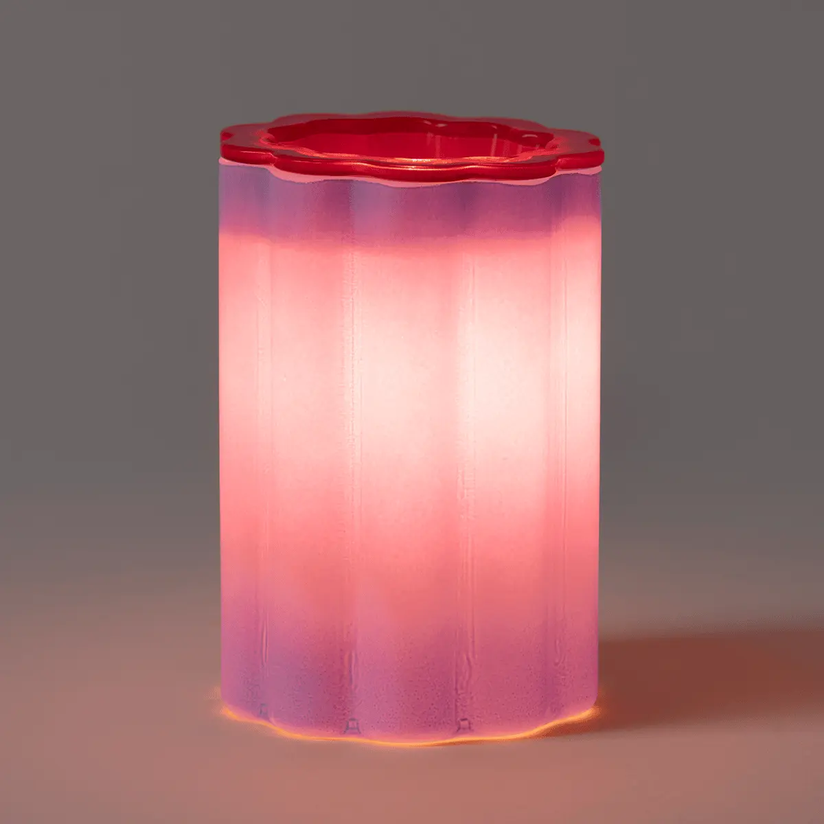 Cylindrical Scentsy Warmer with a gradient of pink, purple, and magenta, topped with a red decorative lid, the Petal Purple Scentsy Warmer