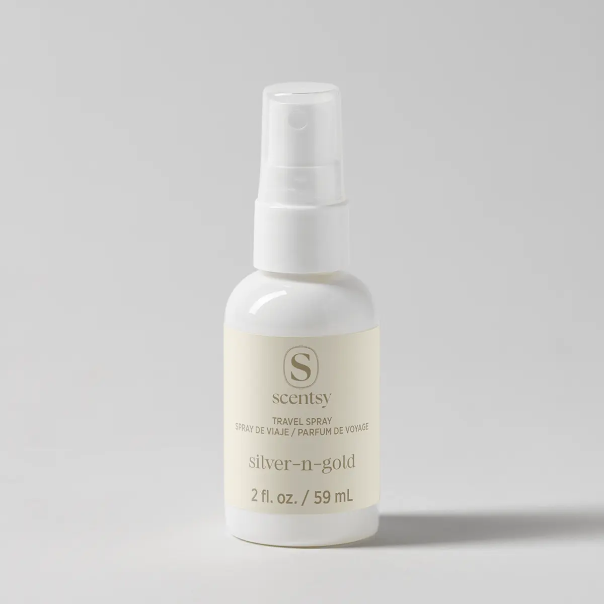 White spray bottle with pump dispenser and pale yellow liquid inside, labelled Silver-N-Gold Travel Spray, 2 fl oz / 59 mL, with Scentsy branding