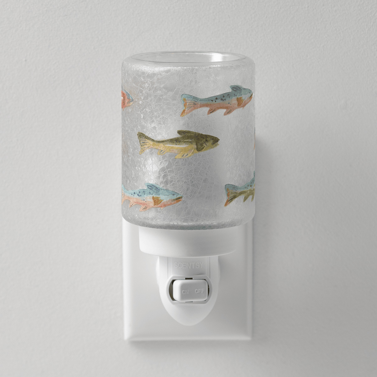 Frosted glass mini warmer with a watercolour fish design in shades of blue, green, and orange, mounted on a white wall-plug base with an on/off switch