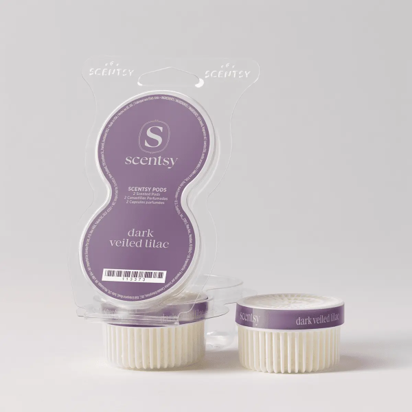 Clear clamshell packaging containing two cream-coloured ridged wax pods with purple bands labelled Dark Veiled Lilac Scentsy Pods, displayed with one pod outside the package