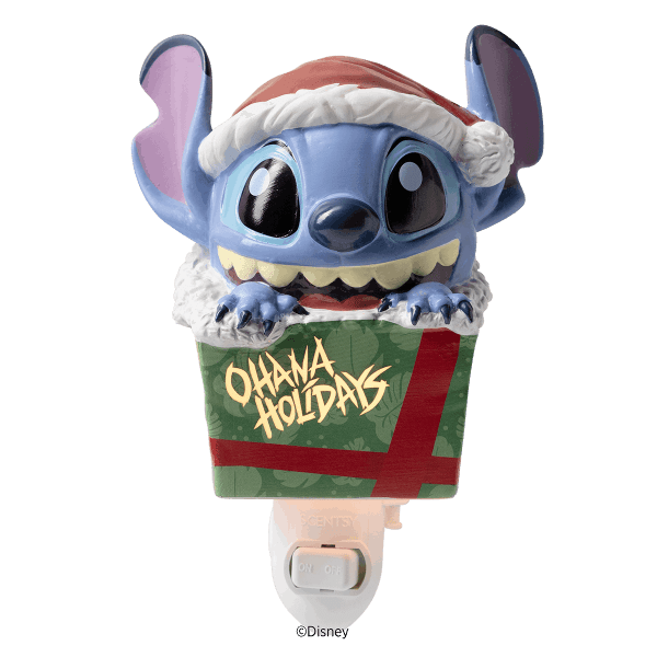 Blue alien character with large ears wearing a red and white Santa hat and white fuzzy collar, emerging from a green gift box with red ribbon, mounted on a white plug-in warmer base—Disney Stitch: Unleash the Holidays Mini Scentsy Warmer
