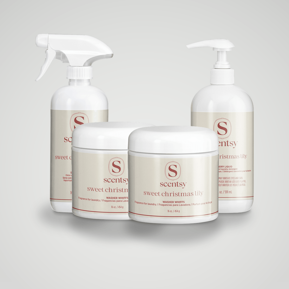 Four white Scentsy laundry products with cream-coloured labels and red branding: two spray bottles, two jars with white lids labelled Sweet Christmas Lily Washer Whiffs, shown as the Holiday Laundry Bundle