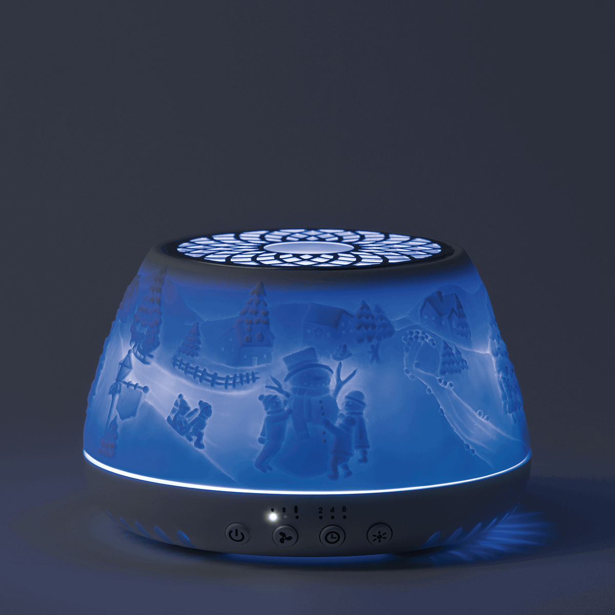 Blue translucent Scentsy Air Quad diffuser with dimensional winter village and character design, black base with control buttons, and illuminated top vent
