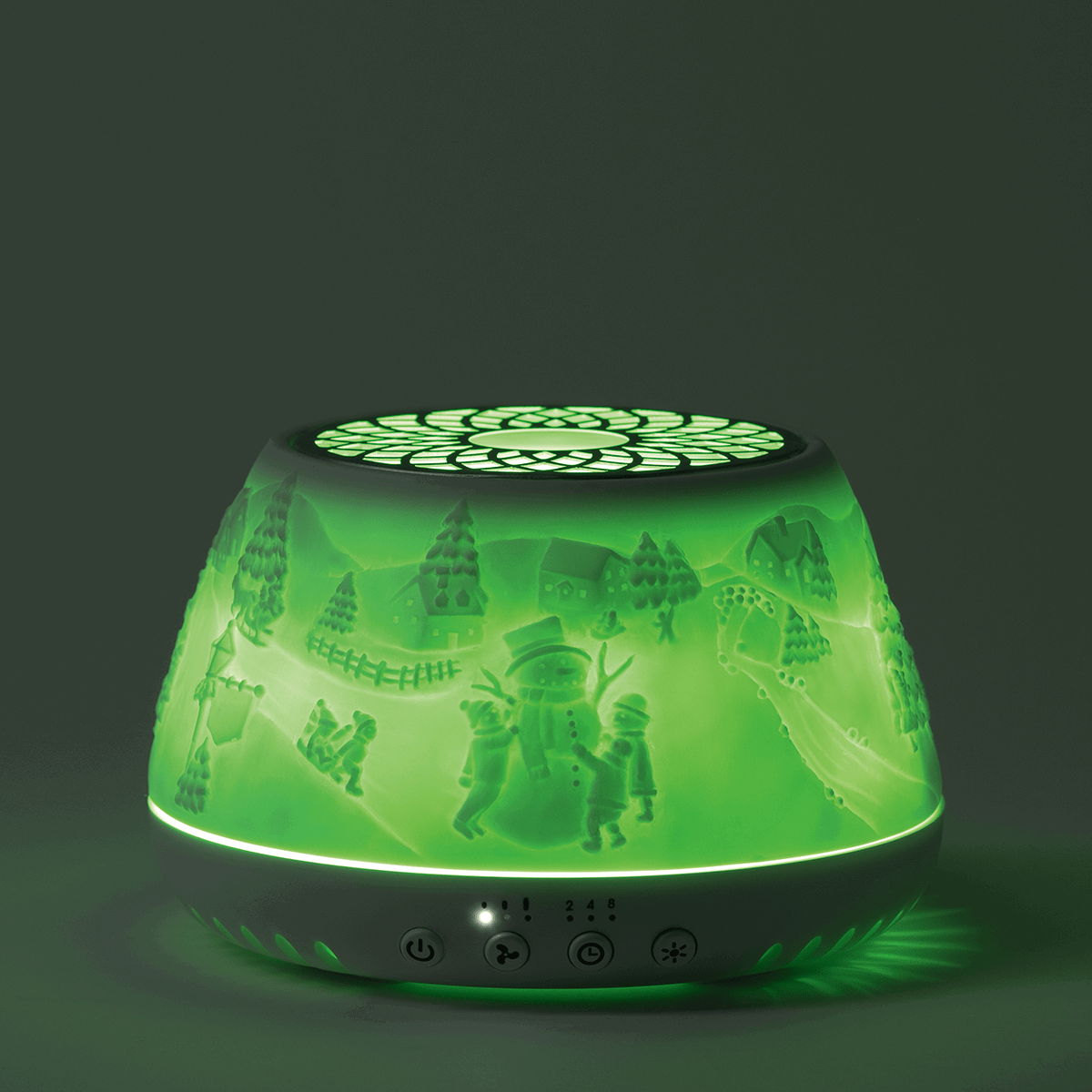 Scentsy Air Quad diffuser with translucent green shade featuring festive winter scene illustrations, glowing green with black top and control buttons at base