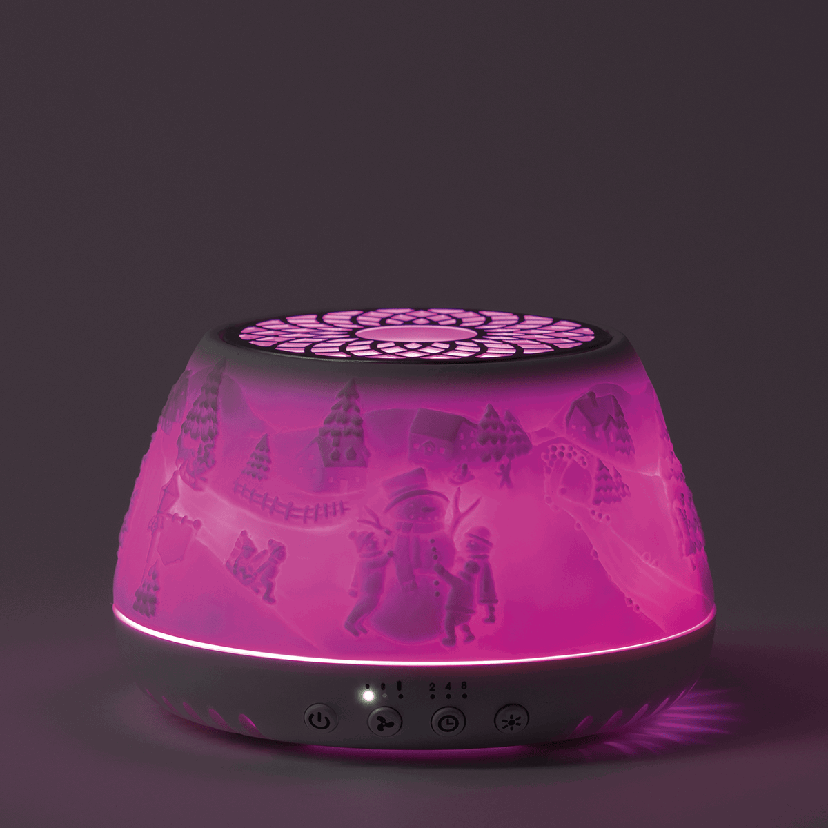 Scentsy Air Quad diffuser with magenta glow, black top, and scene projections of winter characters and trees on the shade