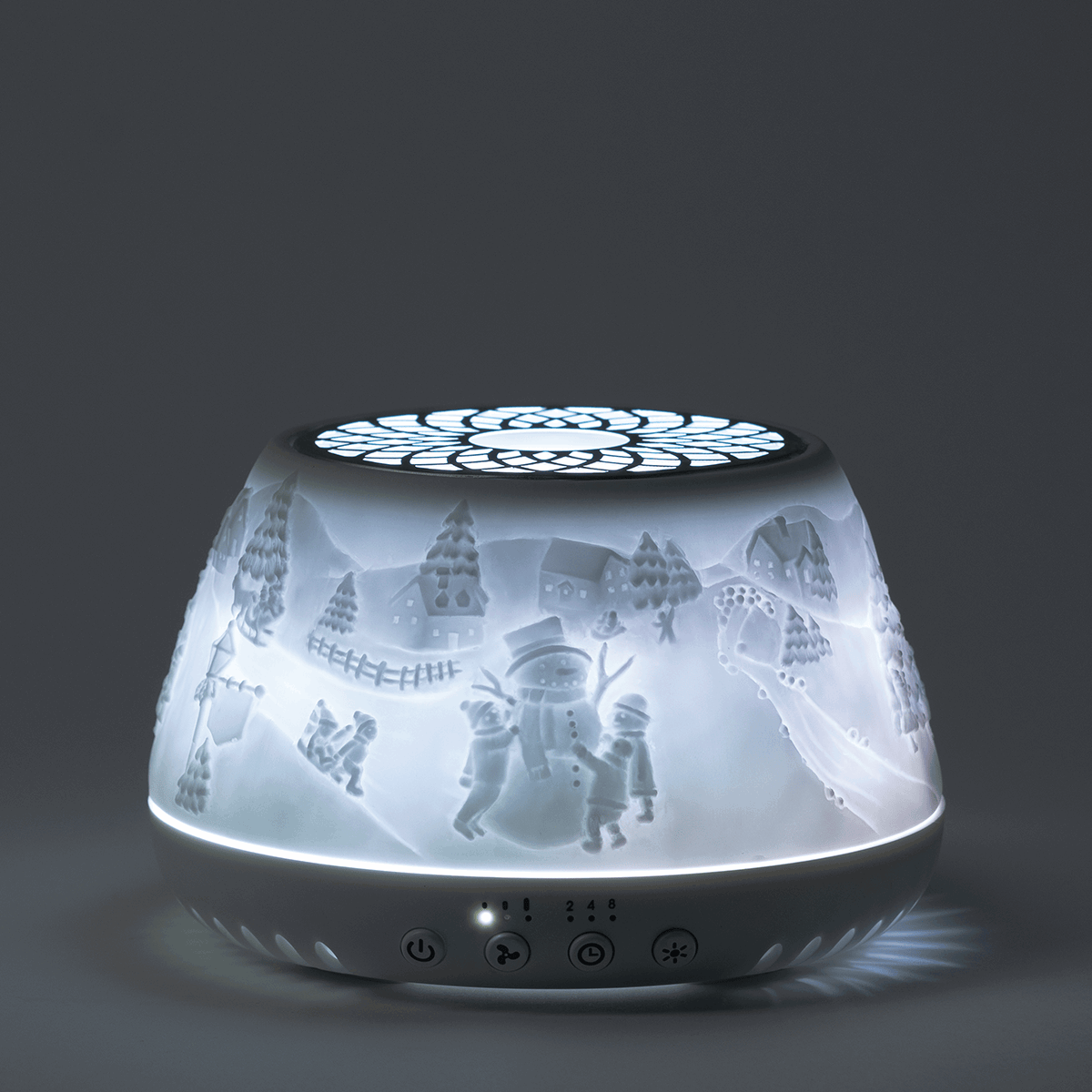 Scentsy Air Quad diffuser with a frosted dome featuring a winter scene of snowmen, evergreen trees, and snow-covered houses, illuminated from within, with control buttons on the base