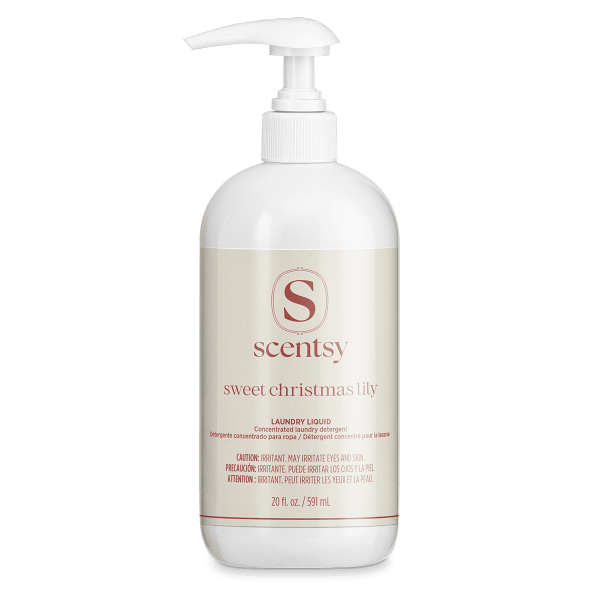 White pump bottle of Scentsy Sweet Christmas Lily Laundry Liquid concentrated detergent, 20 fl oz, with cream label and red text