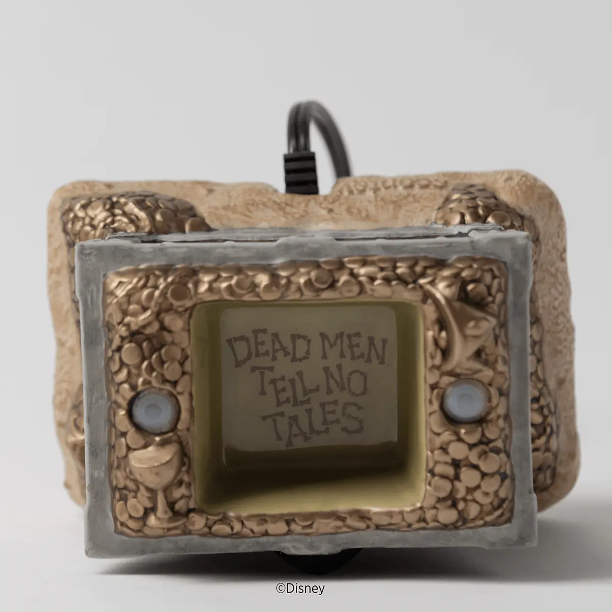 Retro handheld game device warmer with beige textured casing, grey screen bezel, and "Dead Men Tell No Tales" text on the screen, the Disney Pirates of the Caribbean Scentsy Warmer