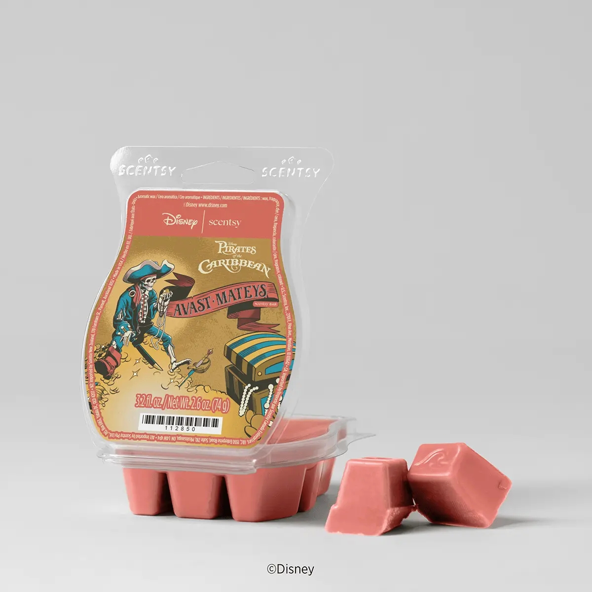 Sealed package of coral-pink Scentsy wax bars featuring Disney Pirates of the Caribbean artwork with Captain Jack Sparrow and a treasure chest, the Disney Pirates of the Caribbean Scentsy Wax Collection, shown with two individual wax cubes displayed in front