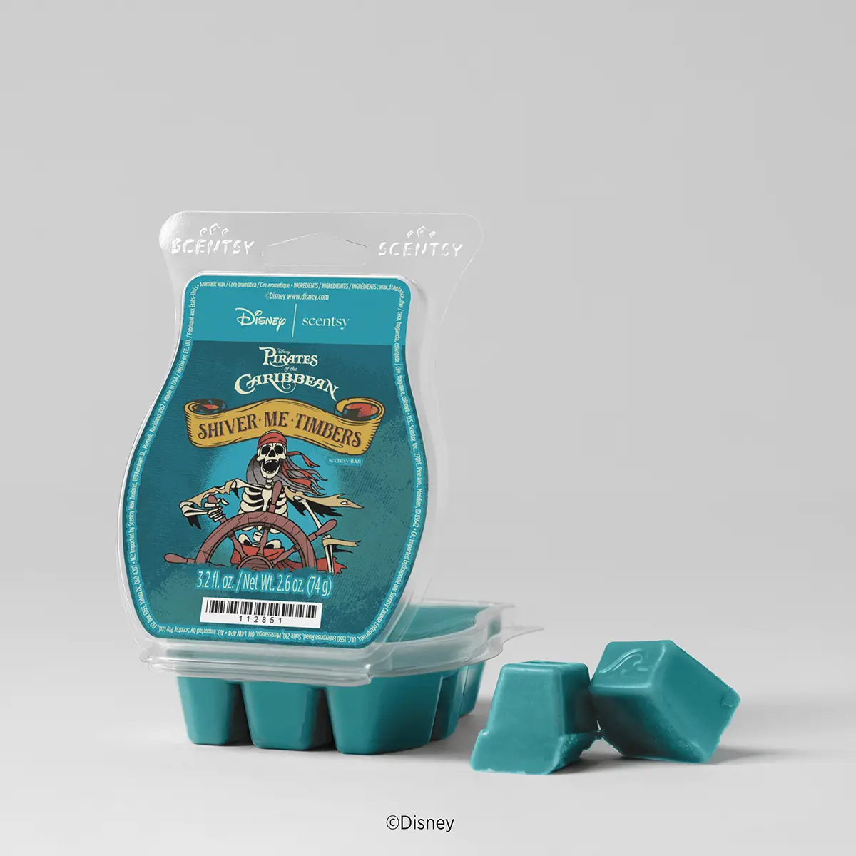 Turquoise clamshell package featuring Disney Pirates of the Caribbean "Shiver Me Timbers" branding with a skull and ship wheel design, containing six turquoise wax cubes, two displayed separately