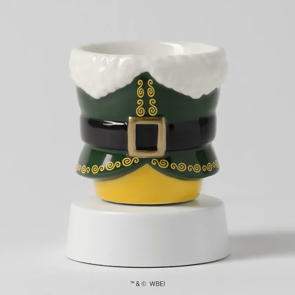 Ceramic mini warmer shaped like Buddy the Elf's costume with a white fur-trimmed green coat, black belt with gold buckle, and yellow tights, sitting on a white tabletop base, the Elf: Buddy’s Christmas Joy Mini Scentsy Warmer with Tabletop Base
