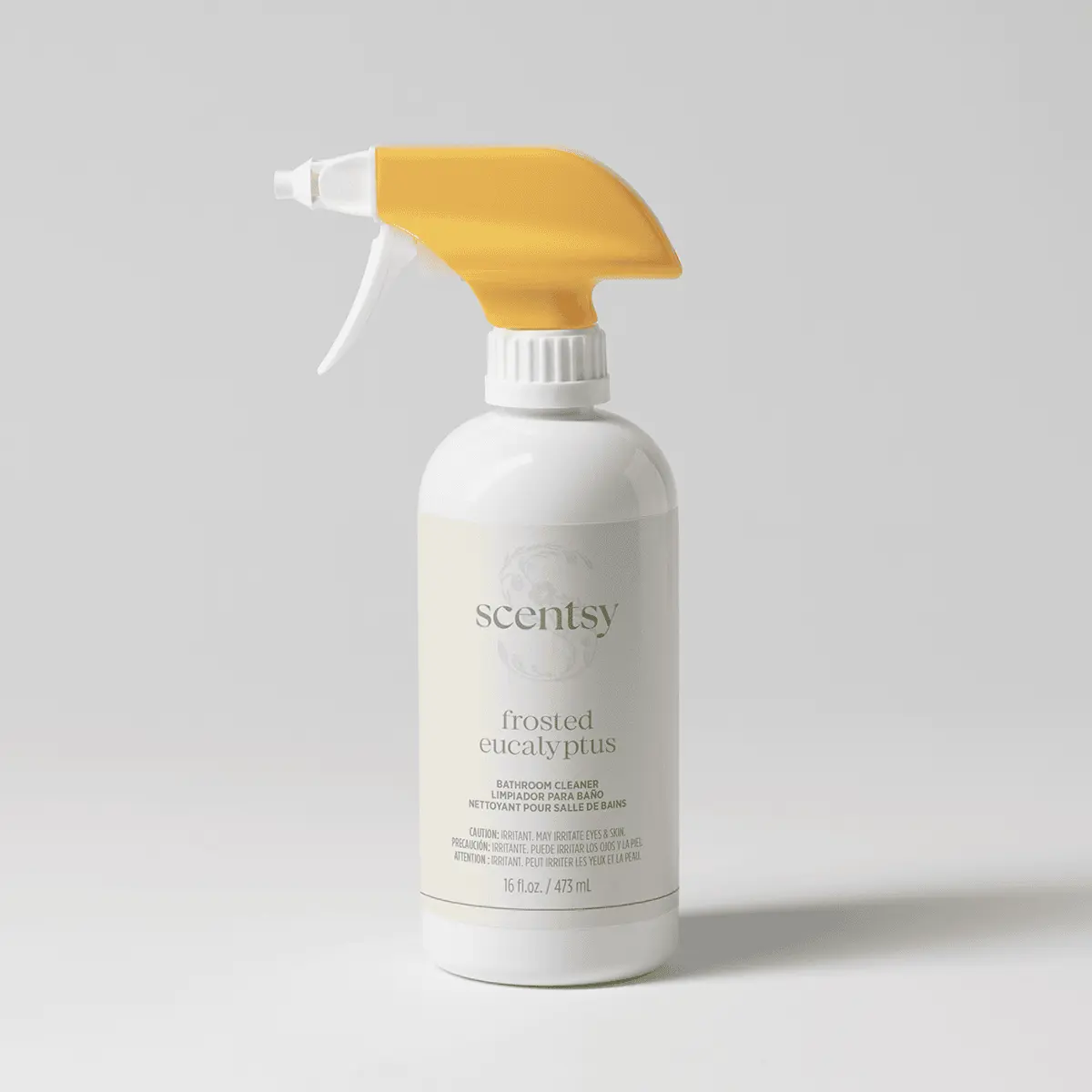 White spray bottle with a yellow trigger top and cream label, the Frosted Eucalyptus Bathroom Cleaner, on a pale grey background