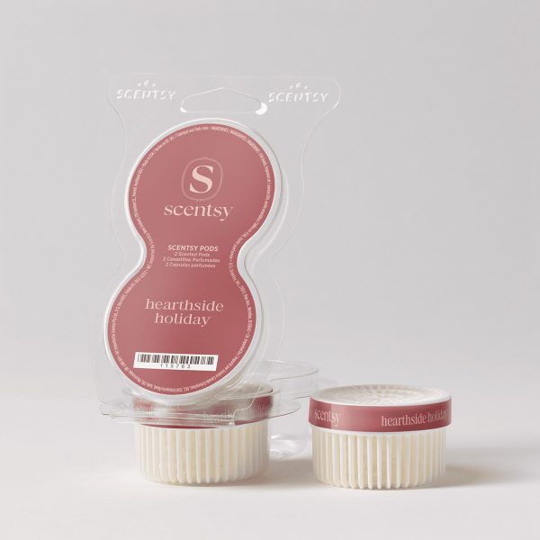Two cream-coloured ribbed Scentsy Pods with mauve-rose labels reading "hearthside holiday" beside their clear plastic clamshell packaging, the Hearthside Holiday Scentsy Pods