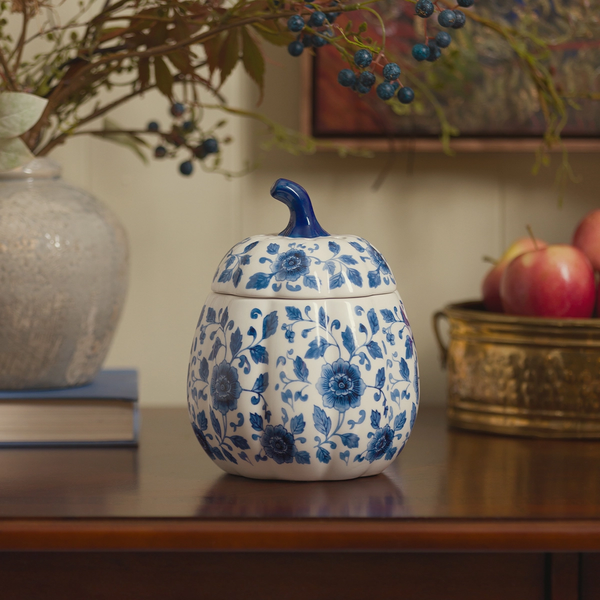 Ceramic warmer in a rounded pumpkin shape with a blue handle, decorated with indigo floral and vine motifs on a cream background, the Indigo Vine Pumpkin Scentsy Warmer