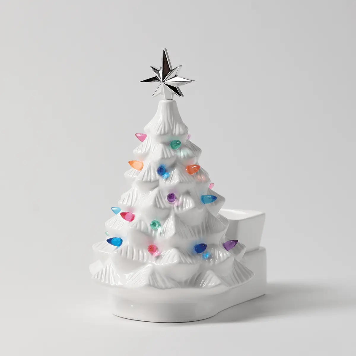 White ceramic Christmas tree warmer with textured branches, multicoloured gemstone ornaments, a star topper, and a white base, the Merry Little Christmas - White Scentsy Warmer