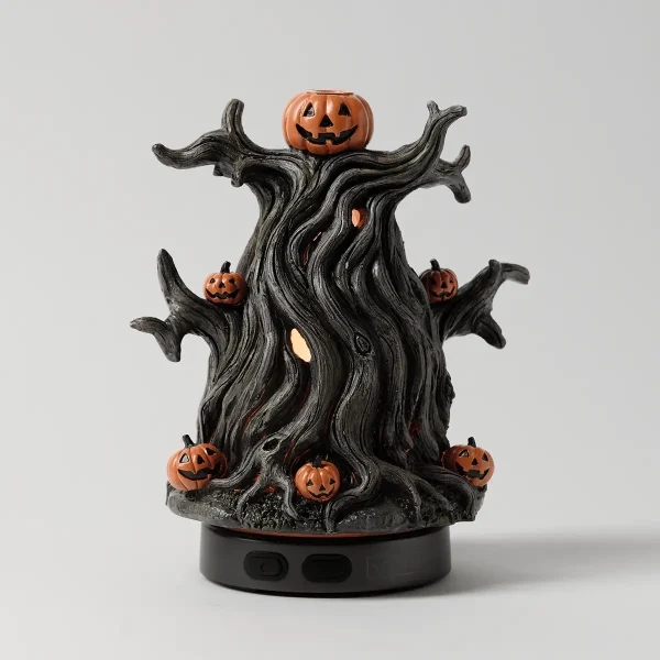 Gnarled black tree trunk diffuser with outstretched branch arms, orange jack-o'-lantern pumpkins perched throughout, and a glowing interior, the Midnight Jack - Scentsy Diffuser