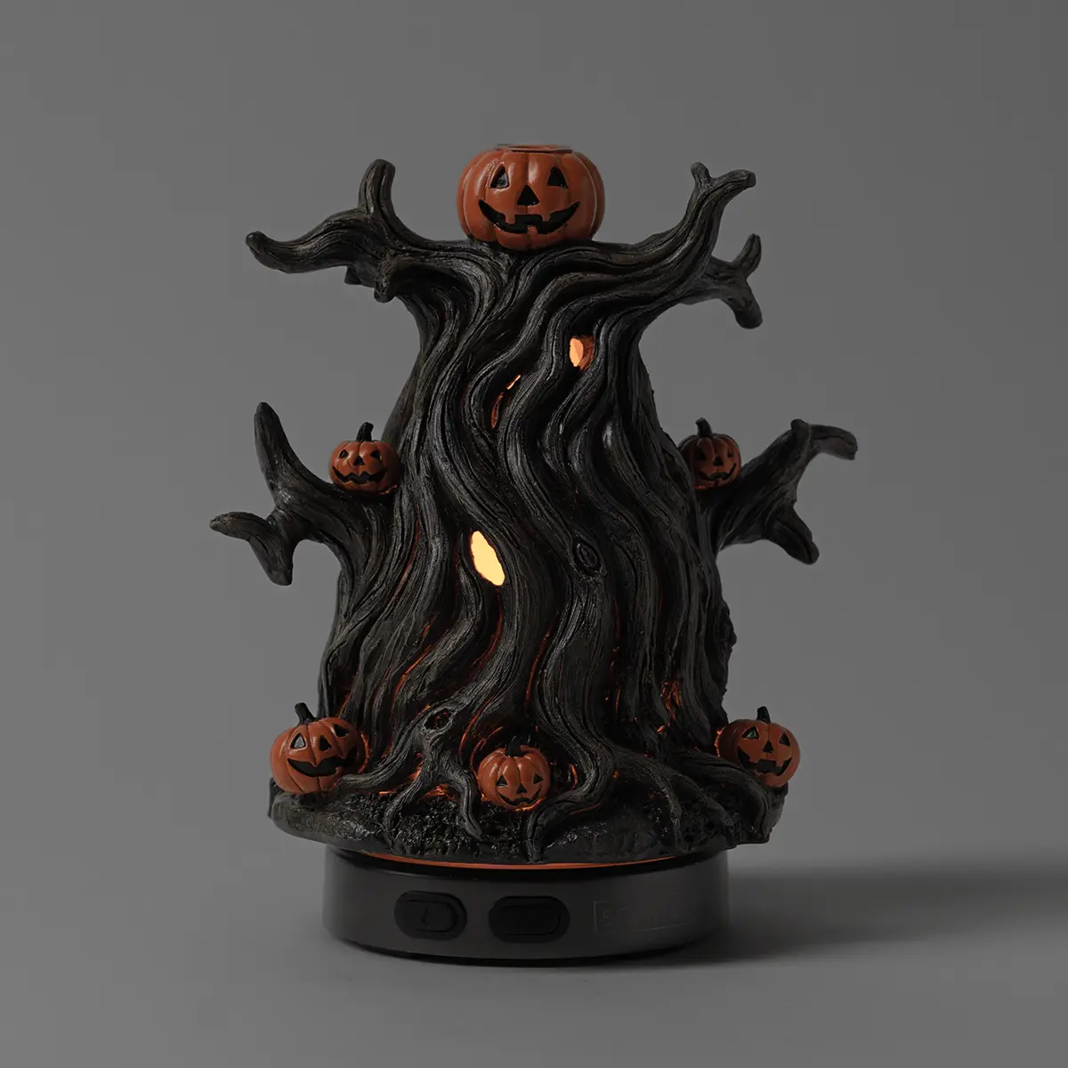 Black gnarled tree with glowing interior cavity details, grinning jack-o'-lantern pumpkins perched on branches and base, the Midnight Jack Scentsy Diffuser