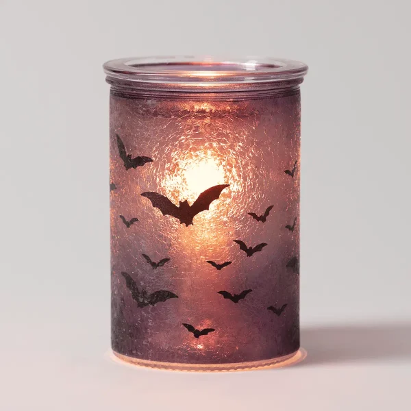 Cylindrical glass warmer in deep mauve with a textured surface, silhouettes of bats flying across a glowing moon, the Nightfall Scentsy Warmer