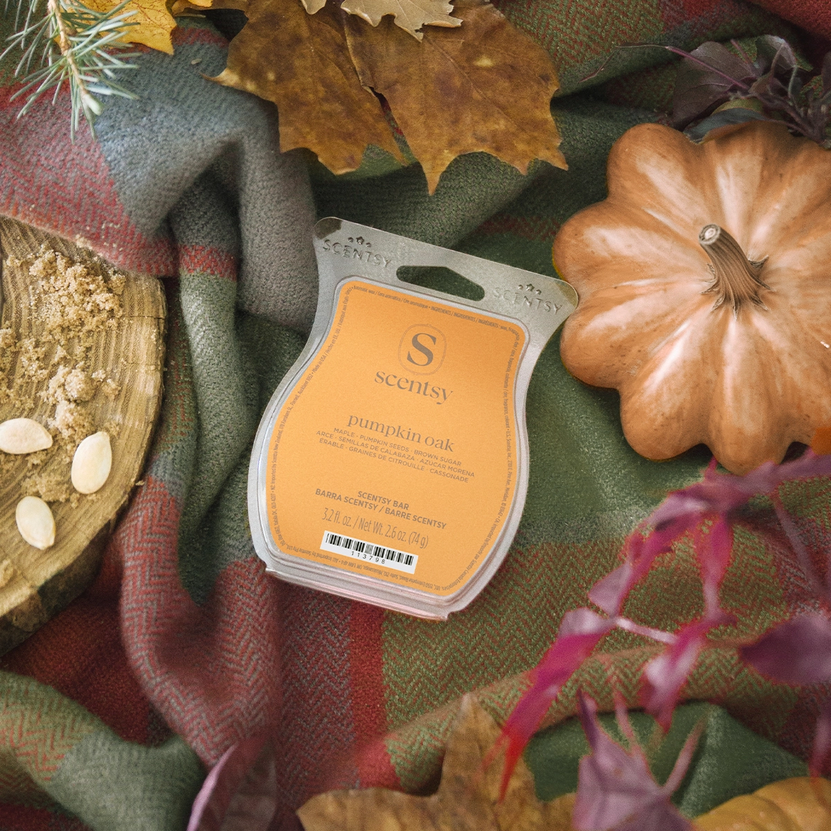 Pumpkin Oak Scentsy Bar wax melt in orange packaging, displayed on autumn fabric with dried leaves and decorative pumpkin