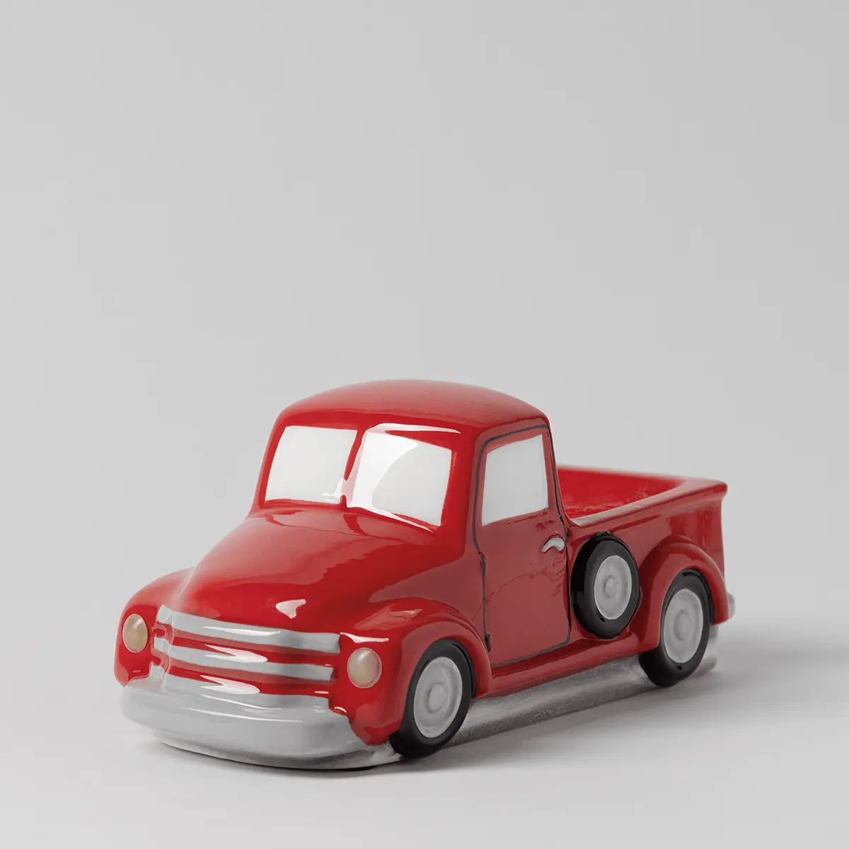 Glossy red ceramic pickup truck warmer with white-wall tyres, silver grille detail, and opening door, the Red Retro Truck Scentsy Warmer