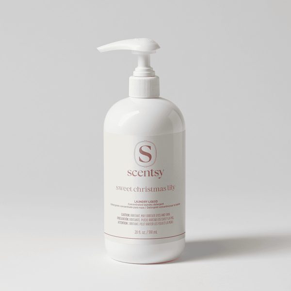 White pump-top bottle with a cream label and dusty rose lettering, holding Sweet Christmas Lily Laundry Liquid, shown against a soft grey background