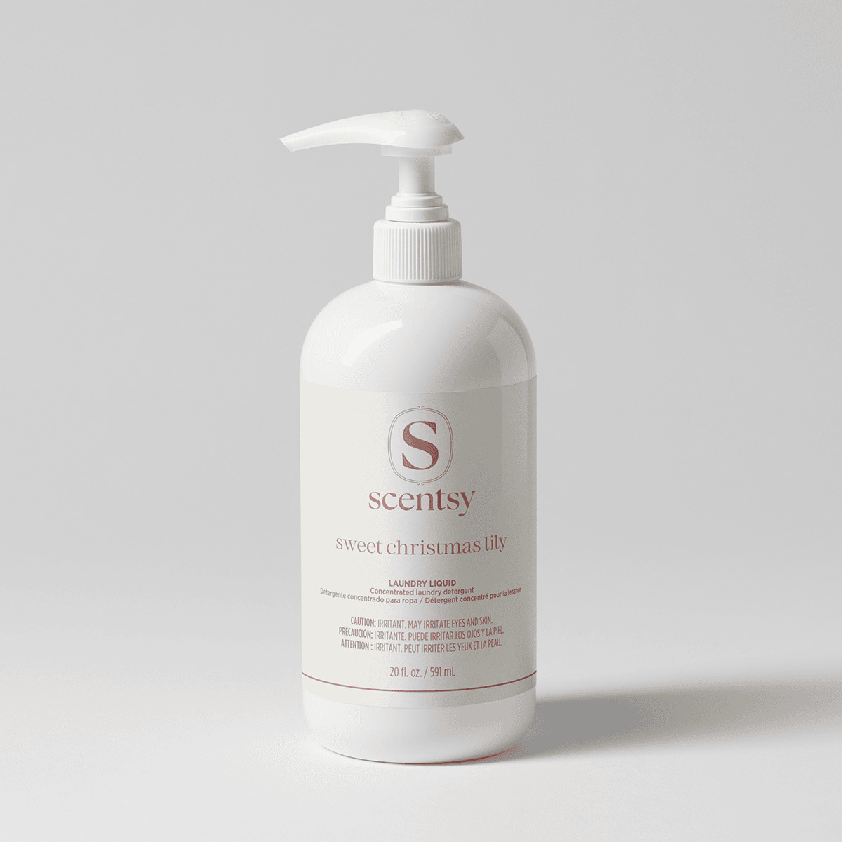 White pump-top bottle with a cream label and dusty rose lettering, holding Sweet Christmas Lily Laundry Liquid, shown against a soft grey background