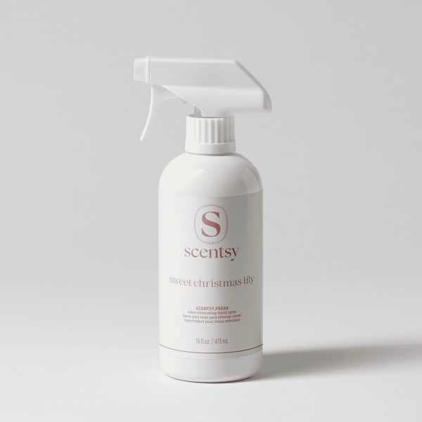 White trigger spray bottle with a matte white label and dusty rose lettering, the Sweet Christmas Lily Scentsy Fresh fabric spray, on a pale grey background