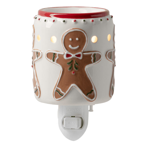 White ceramic plugin warmer with gingerbread man and candy cane designs, red trim at the top, and light-up cutouts, the Gingerbread Snap Mini Scentsy Warmer