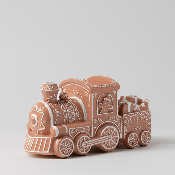 Terracotta-coloured ceramic train warmer with white icing-like piped detailing, gingerbread-style decorations, wheels, and a cargo car holding wrapped presents, The Ginger Line Scentsy Warmer