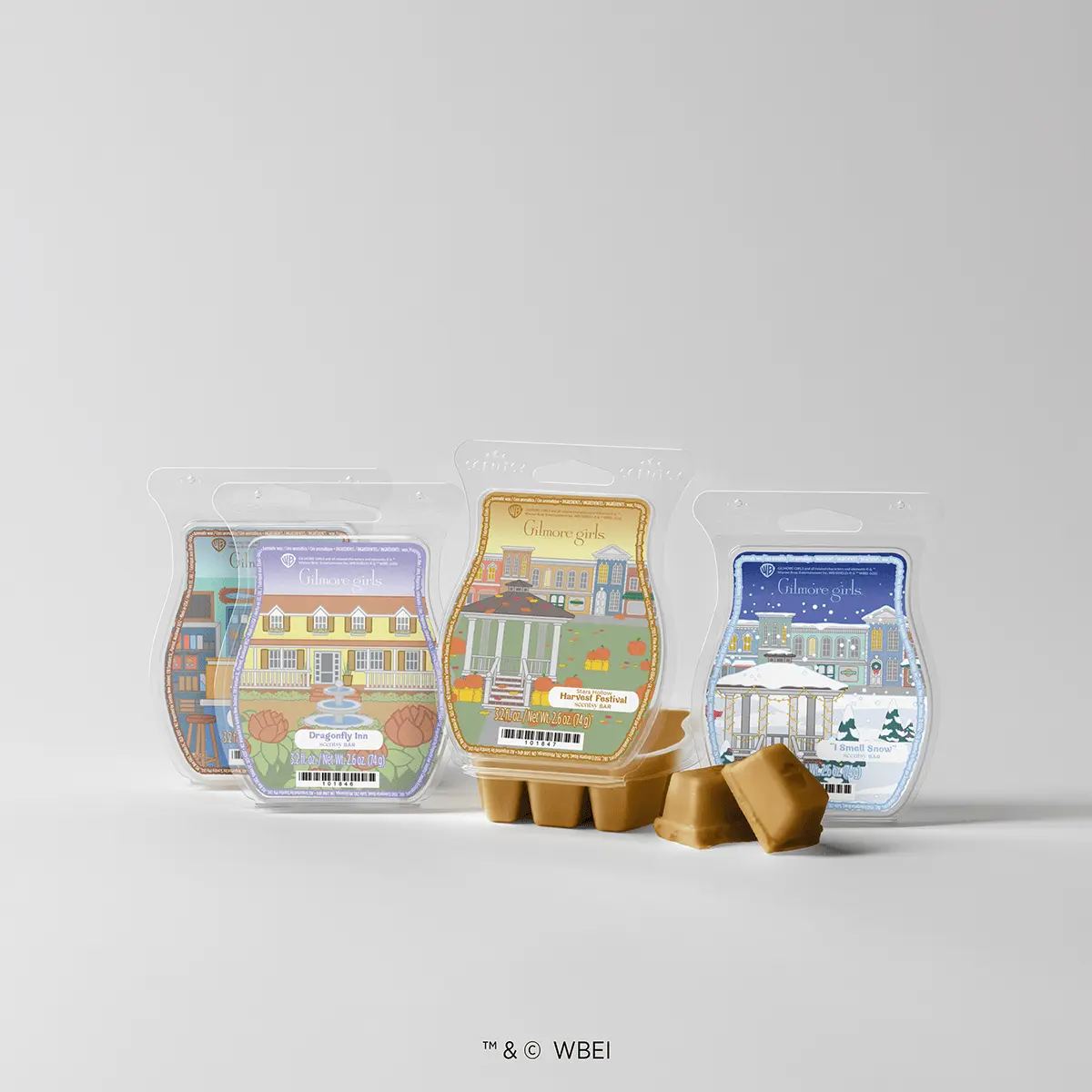 Three Scentsy wax melts clamshells with Gilmore Girls artwork displaying iconic locations, gold wax melts scattered in front, the A Stroll Through Stars Hollow - Scentsy Wax Bundle