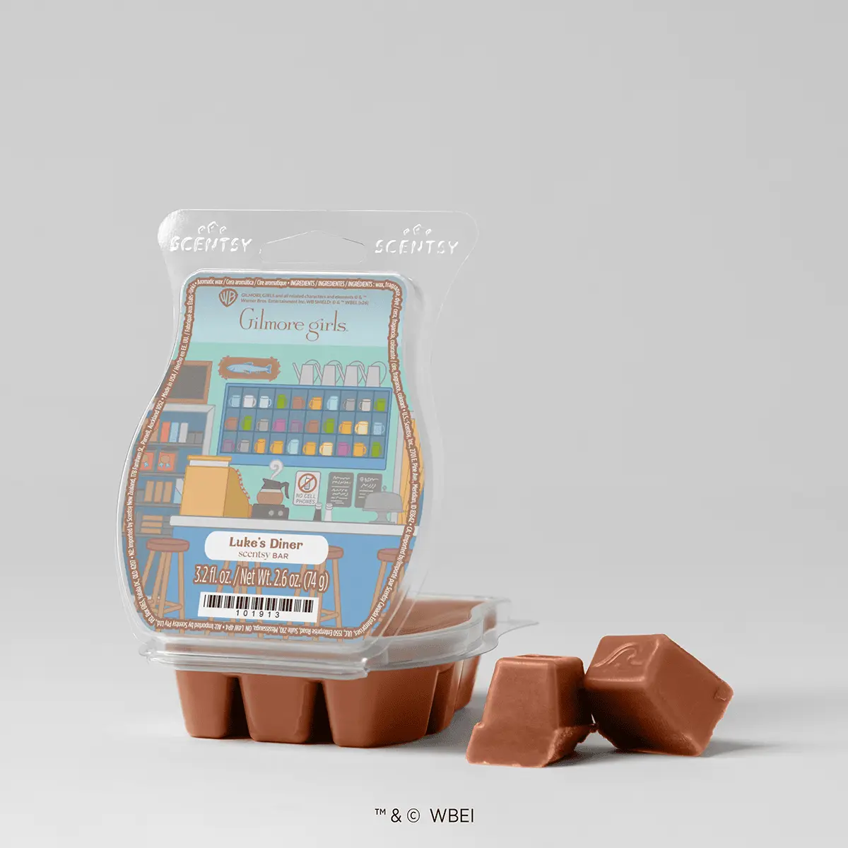 Scentsy Wax Bar with Gilmore Girls packaging featuring Luke's Diner scene in turquoise and brown, shown in terracotta wax melt clamshell with two individual wax cubes displayed beside it