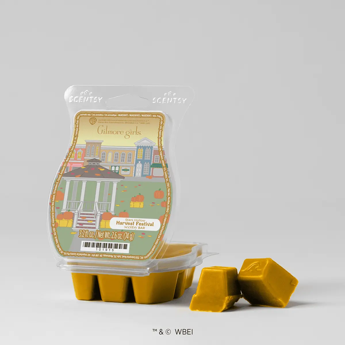 Golden-yellow scented wax bar in clear packaging featuring Gilmore Girls Stars Hollow artwork with colourful buildings and autumn pumpkins, Stroll Through Stars Hollow Scentsy Bar